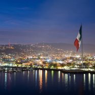 Aerial night shot of Ensenada, Mexico with huge mexican flag